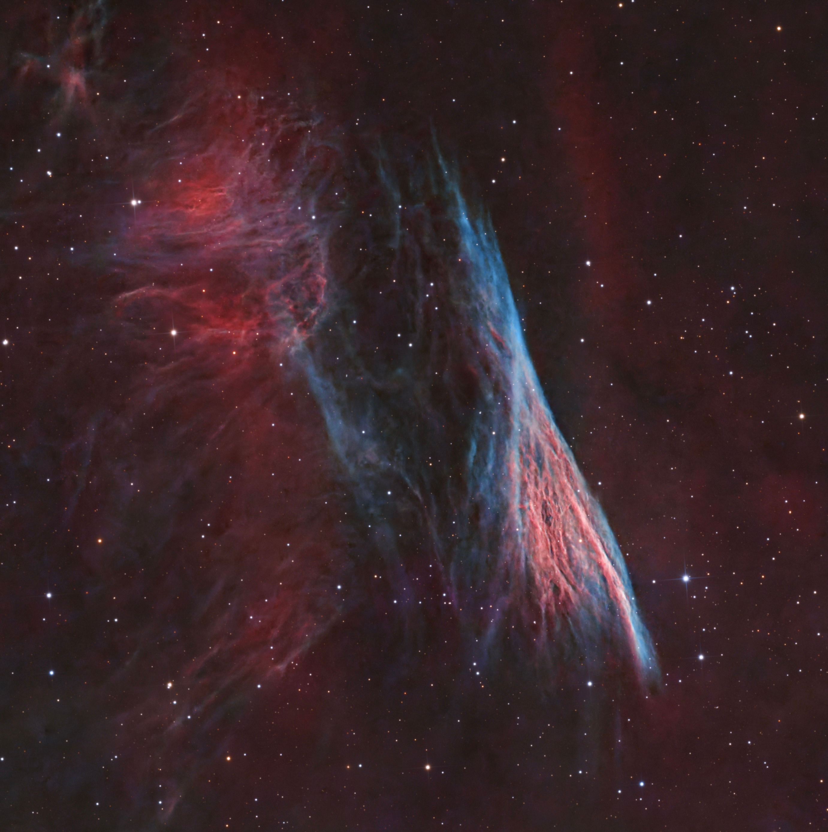 A slender blue nebular filament crossing a subdued red and charcoal background.